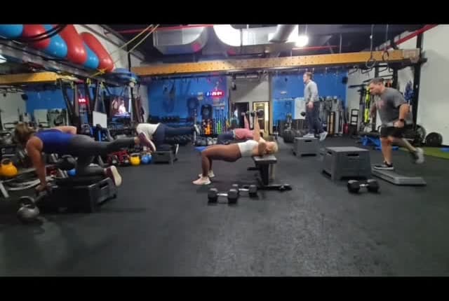 A full strength class training on the studio floor